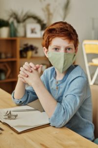 Boy wearing face mask before pediatric dentist in Northampton.