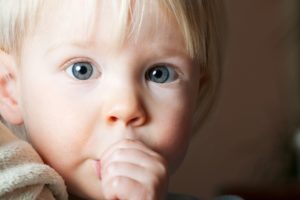 Young boy at pediatric dentist in Northampton sucking thumb.