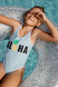 Young girl in pool after visiting pediatric dentist