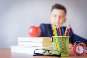 Boy sitting at desk in classroom