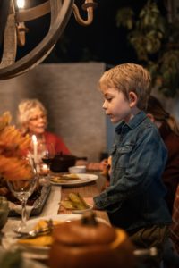 Young boy at Thanksgiving dinner table
