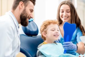 Young boy at dentist looking in a mirror